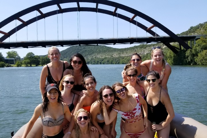 girls partying on a pontoon boat on the lake