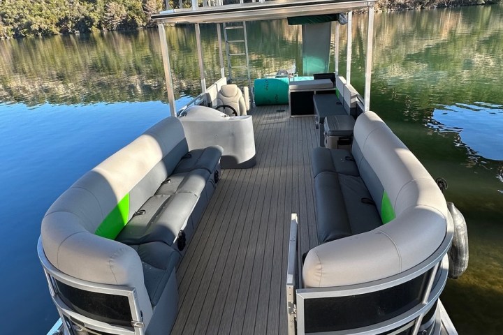 a woman sitting on a dock next to a body of water